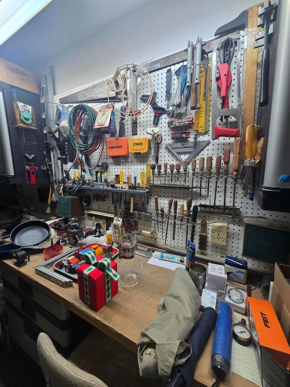 Busy workshop: tools on workbench and hanging on wall