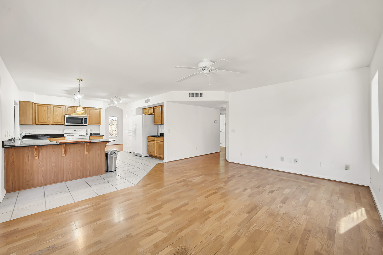 Open-concept kitchen and living room with wood floors