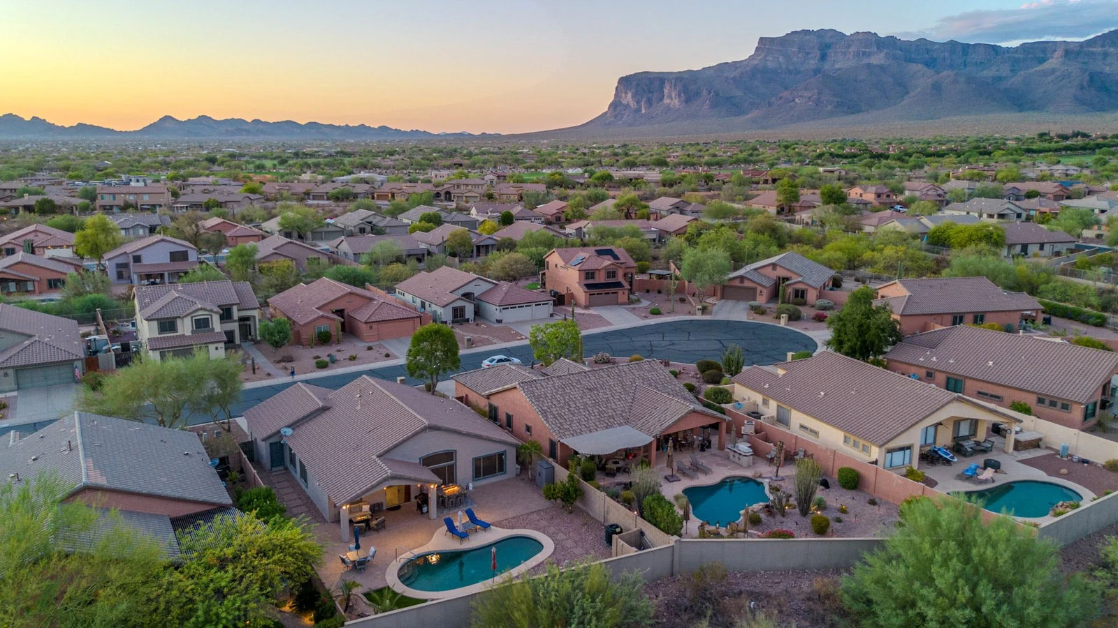 Aerial view desert homes pools mountains sunset real estate photography Gold Canyon AZ | The Listing Bees