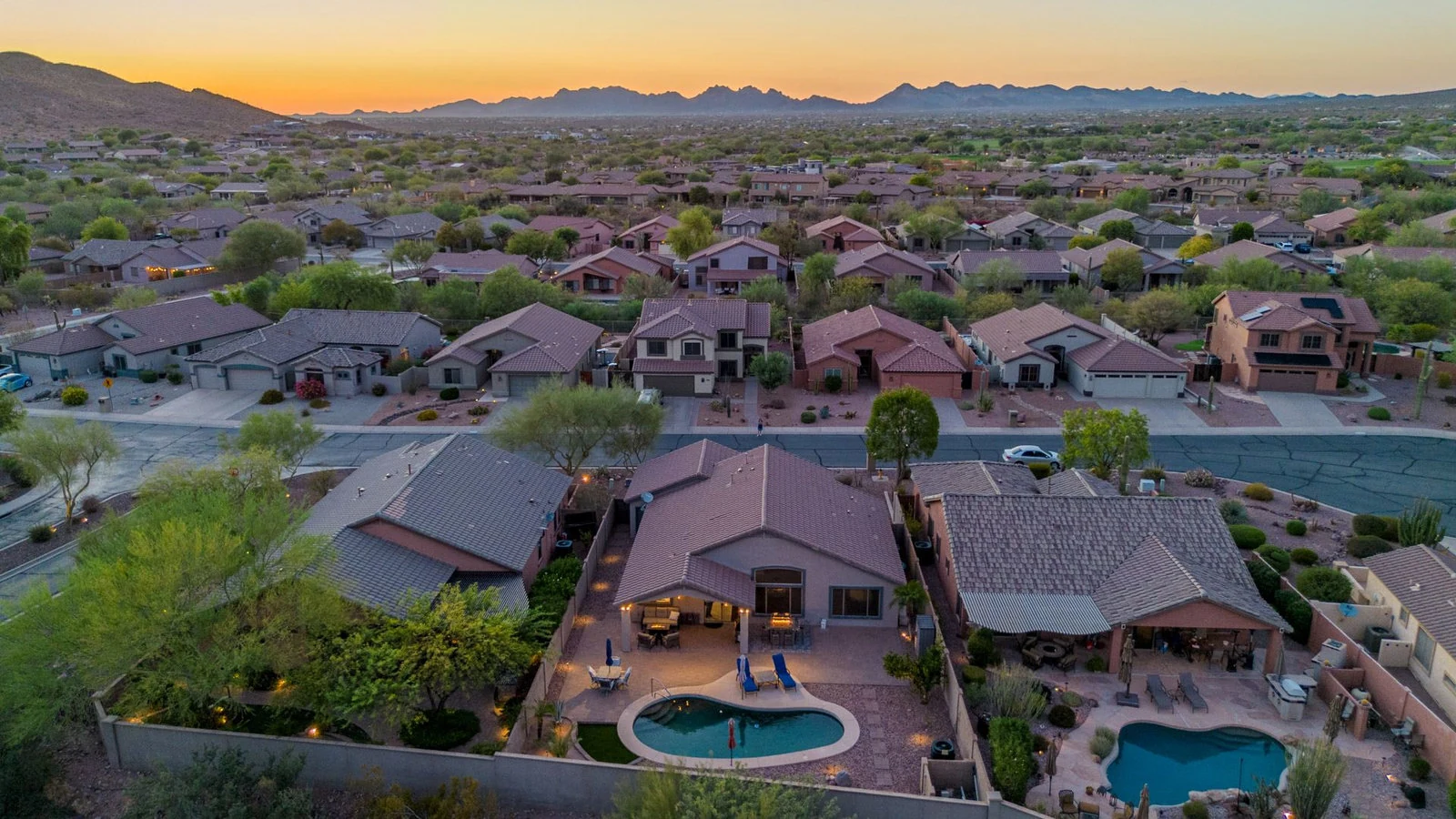 Aerial view desert neighborhood houses pools sunset real estate photography Gold Canyon AZ | The Listing Bees