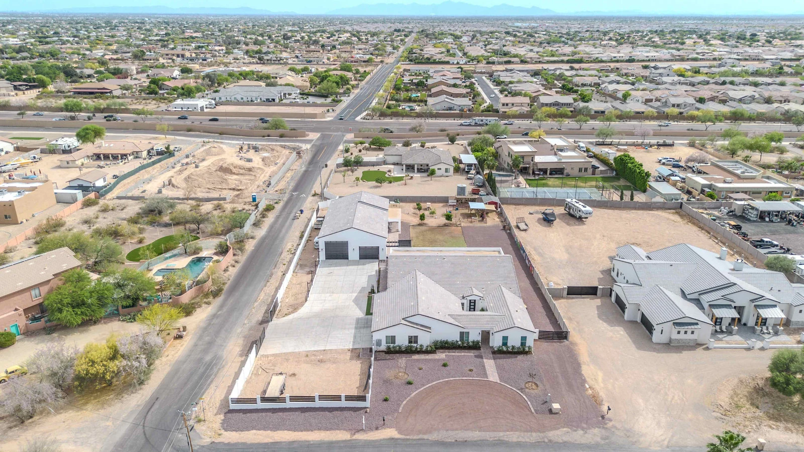 Aerial view of a house with a pool in a desert town