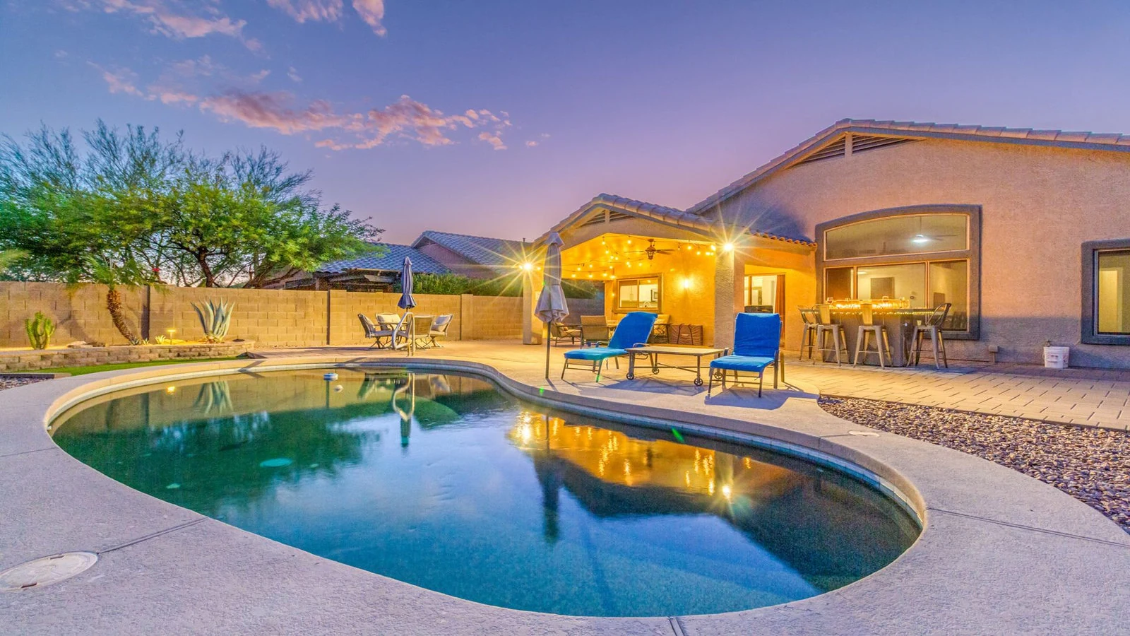 Backyard swimming pool illuminated patio dusk real estate photography Gold Canyon AZ | The Listing Bees