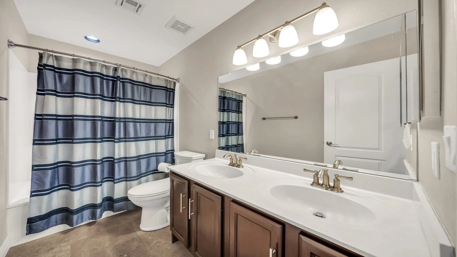 Bathroom double vanity blue striped shower curtain real estate photography Glendale AZ | The Listing Bees