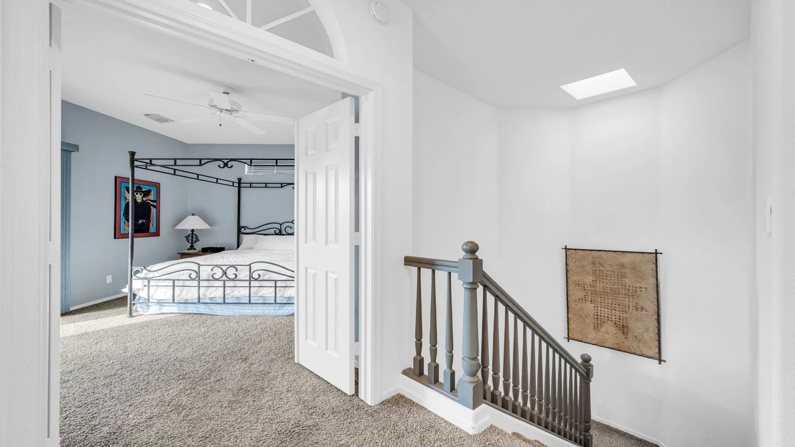 Bedroom four-poster bed staircase skylight real estate photography Ahwatukee AZ | The Listing Bees