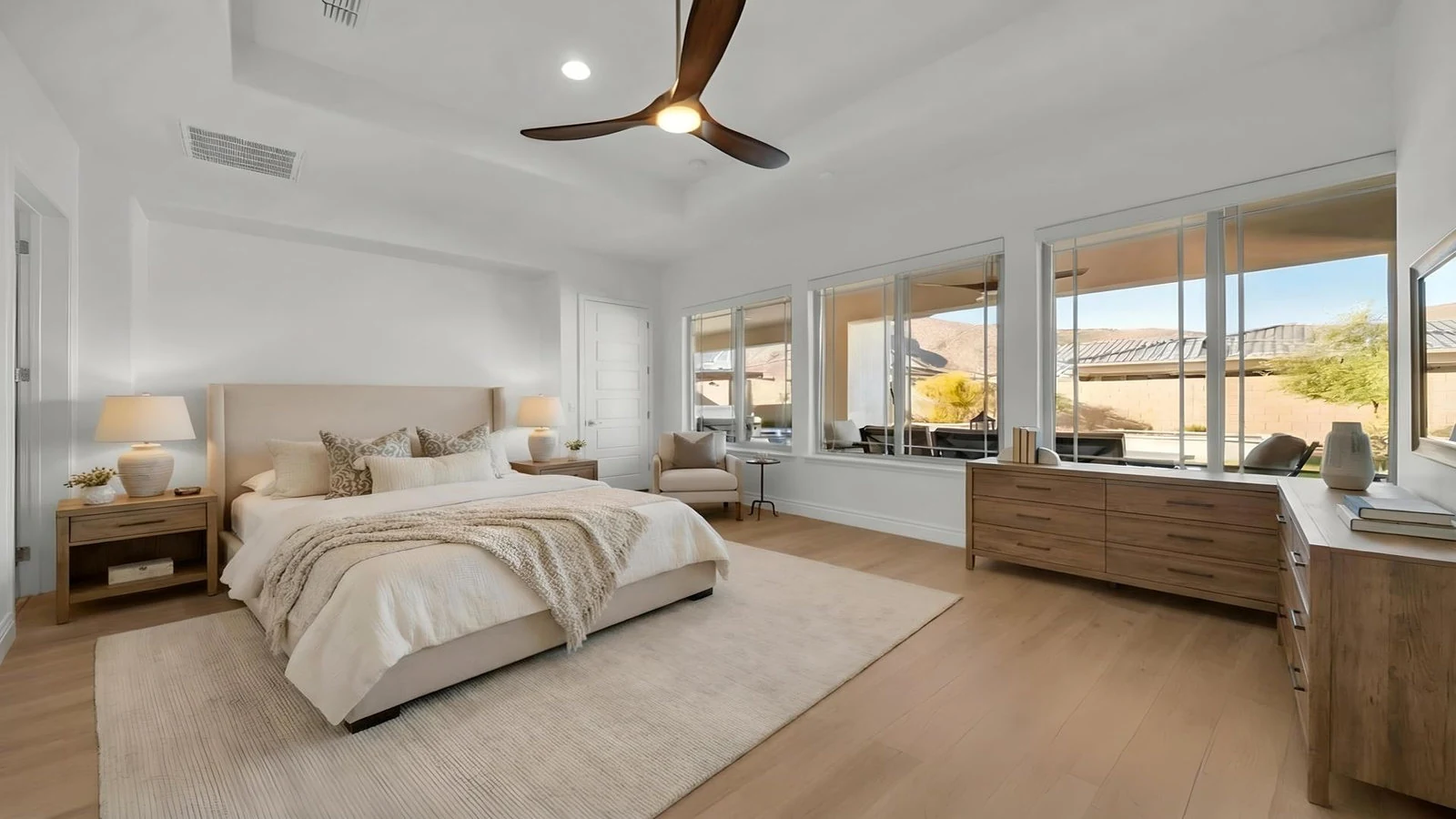 Bedroom large bed wooden dresser patio view real estate photography Buckeye AZ | The Listing Bees