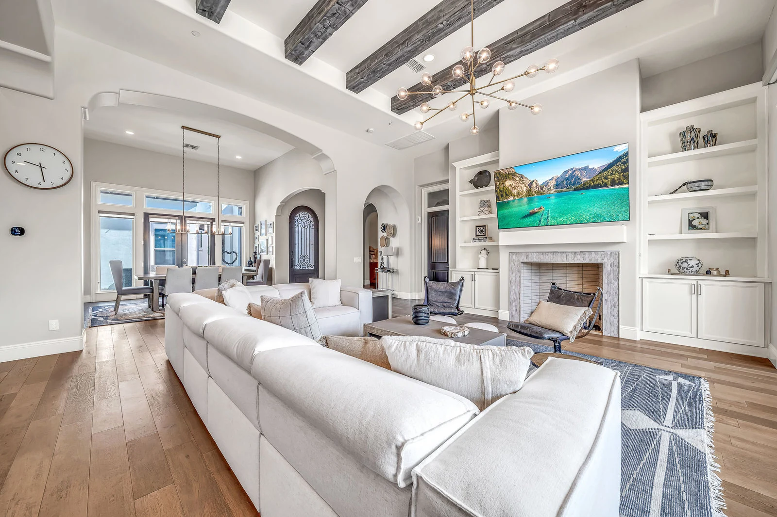 Bright living room white sofa fireplace wood beams real estate photography Cave Creek AZ | The Listing Bees