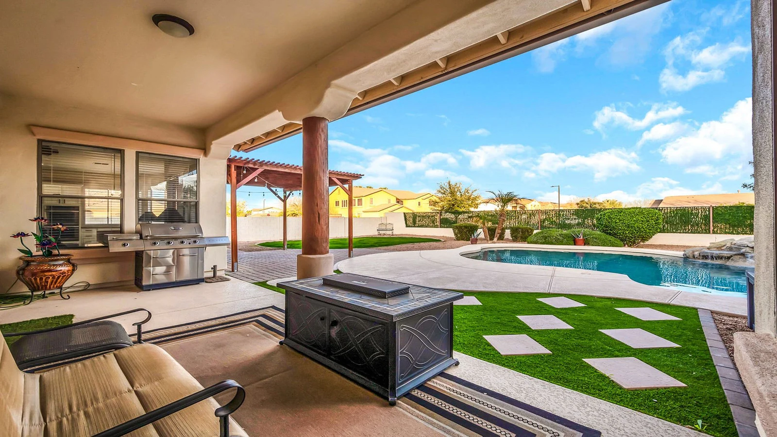 Covered patio fire pit seating backyard pool real estate photography Queen Creek AZ | The Listing Bees
