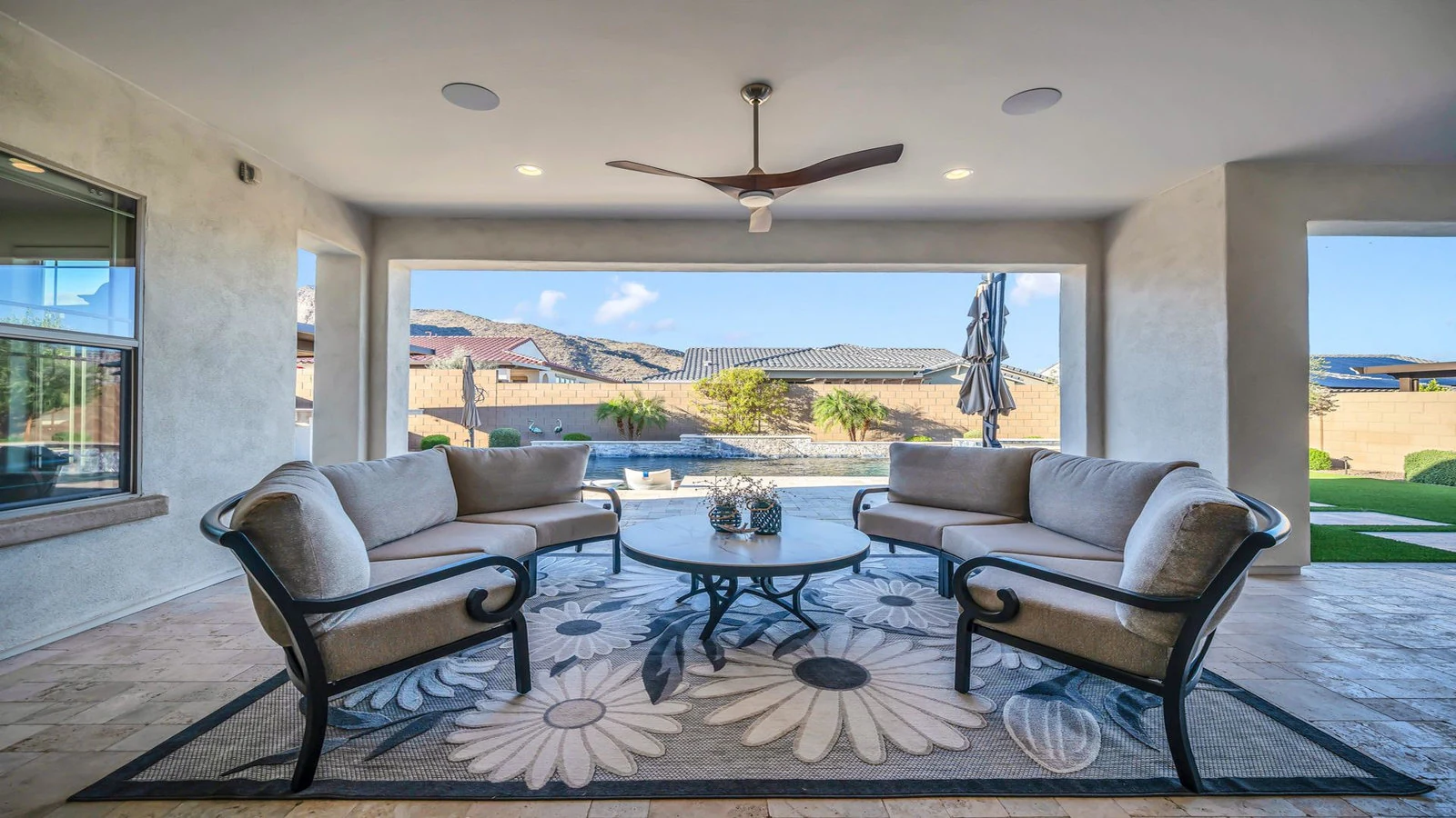 Covered patio seating with pool and mountain view