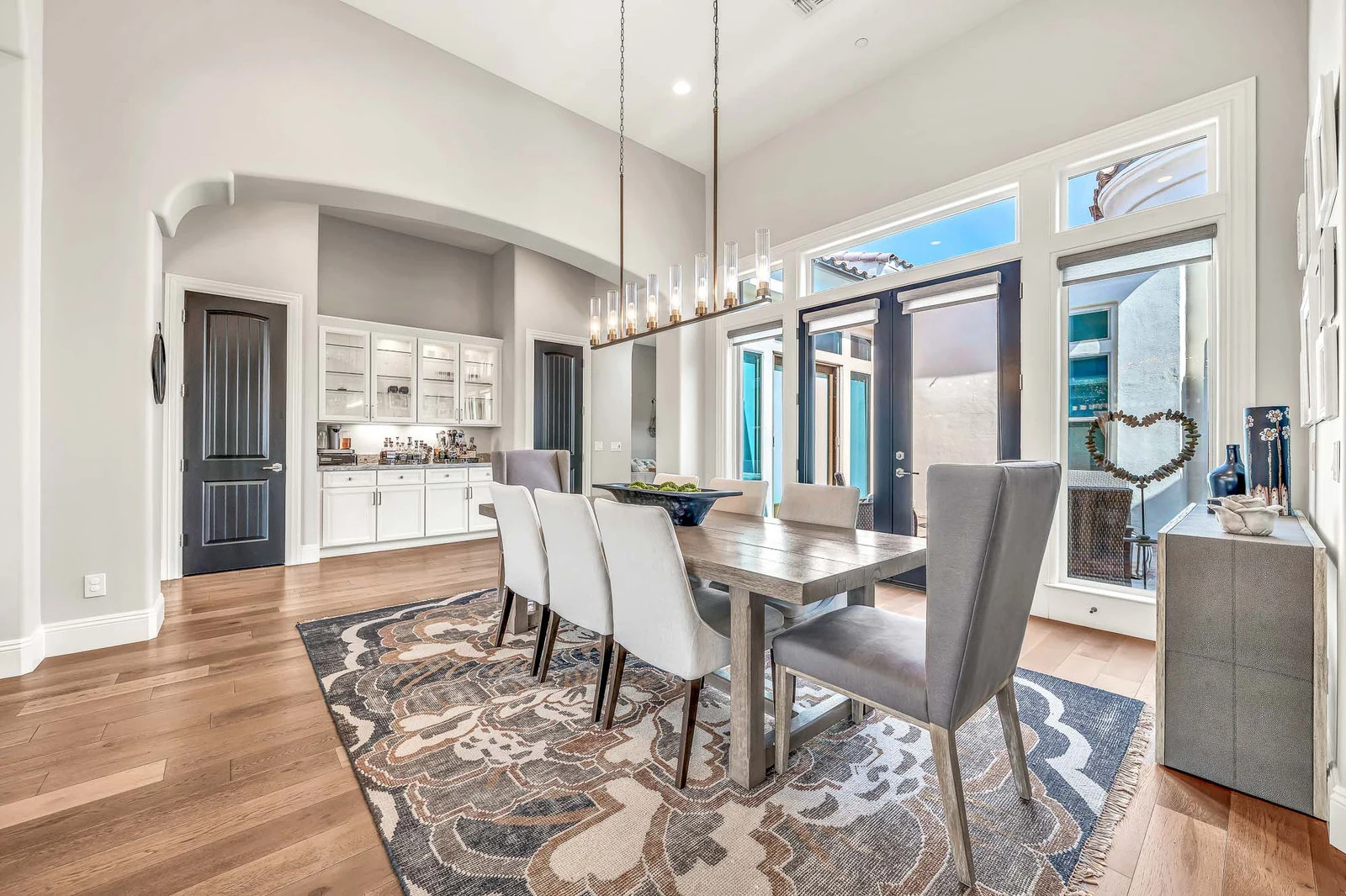 Dining room long table modern chairs chandelier large windows real estate photography Cave Creek AZ | The Listing Bees