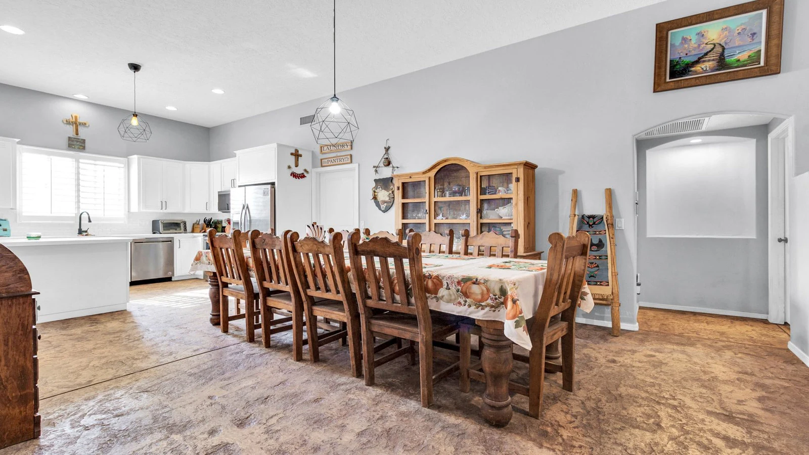 Dining room long wooden table open kitchen real estate photography Apache Junction AZ | The Listing Bees