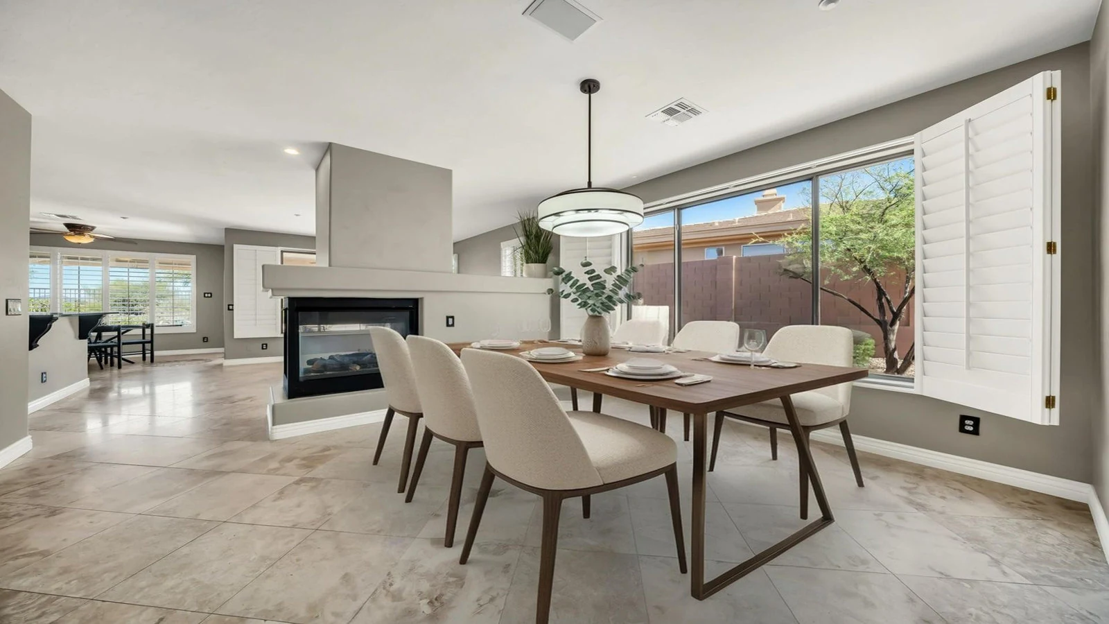 Dining room wooden table fireplace window real estate photography Anthem AZ | The Listing Bees