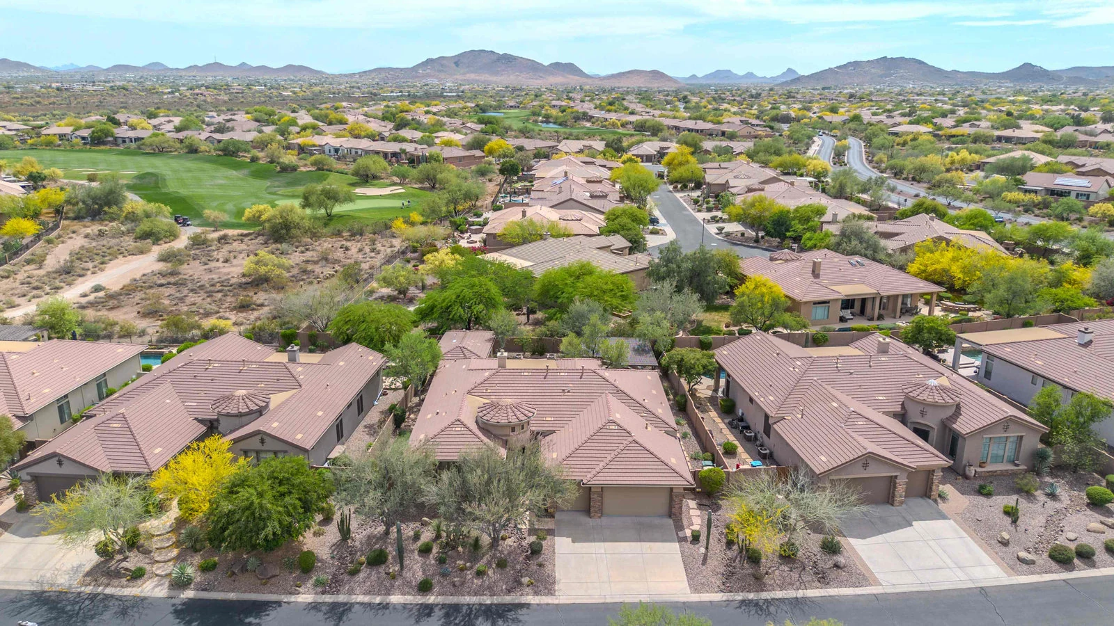 Aerial view of homes, parks and open desert in Eastmark, Mesa, AZ