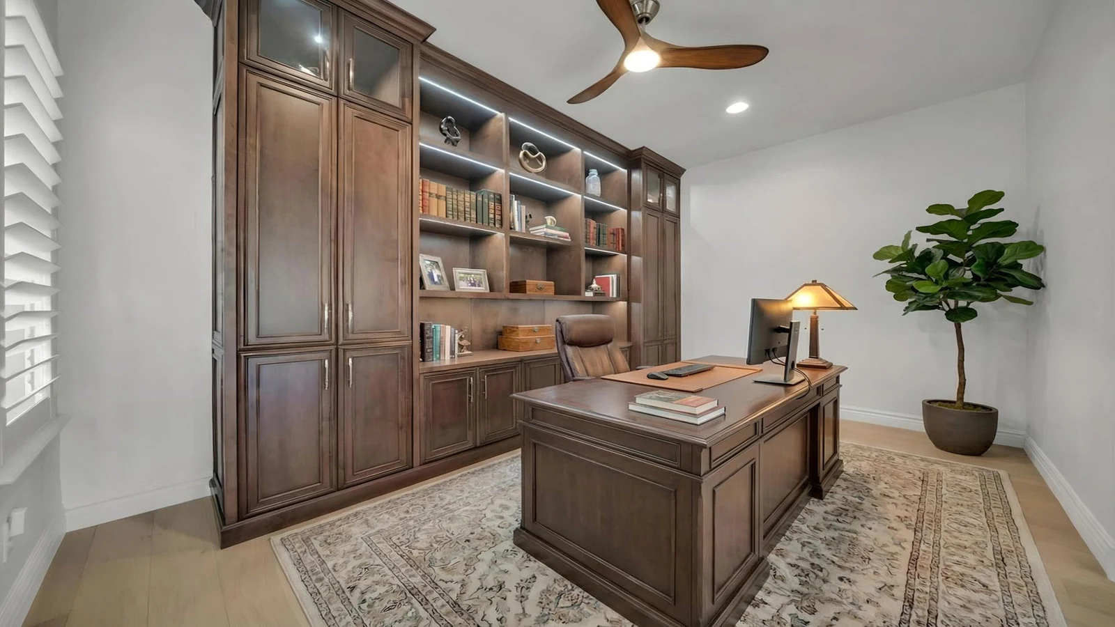 Elegant home office with wooden desk and built-in library