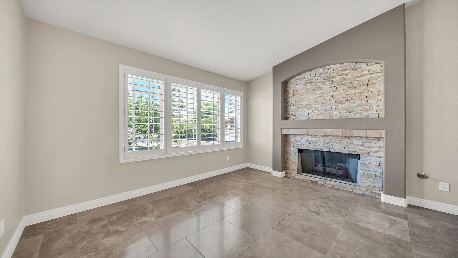 Empty room stone fireplace large window real estate photography Glendale AZ | The Listing Bees