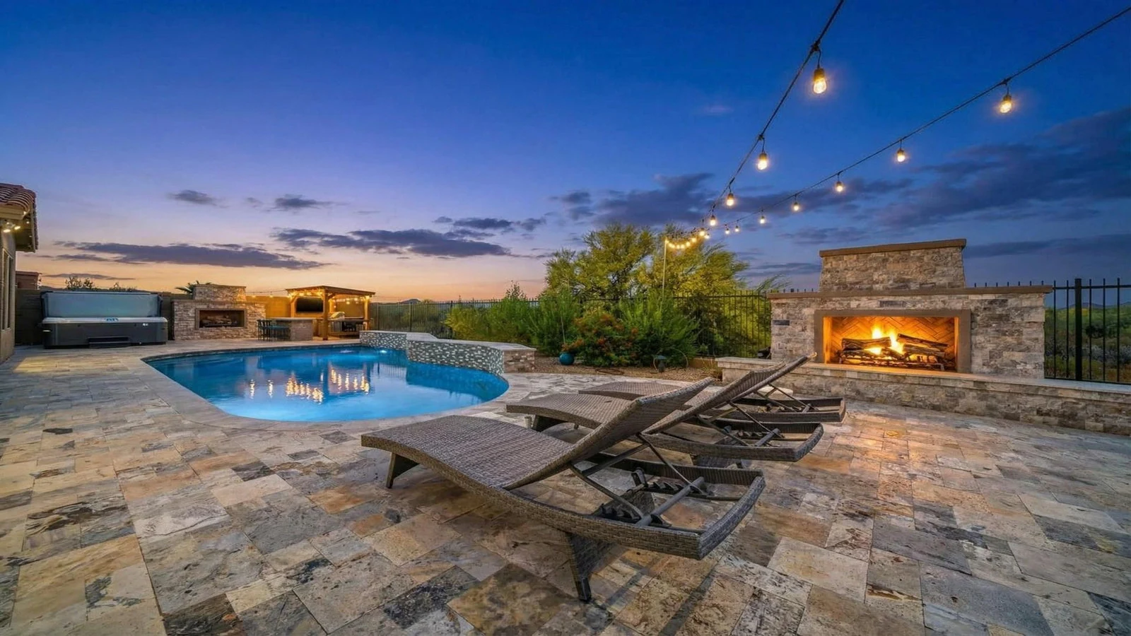 Luxury patio pool fireplace string lights dusk real estate photography Anthem AZ | The Listing Bees