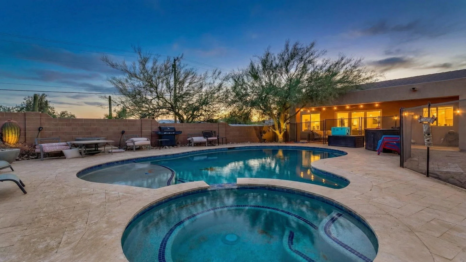 Guitar-shaped pool and hot tub at twilight, Apache Junction