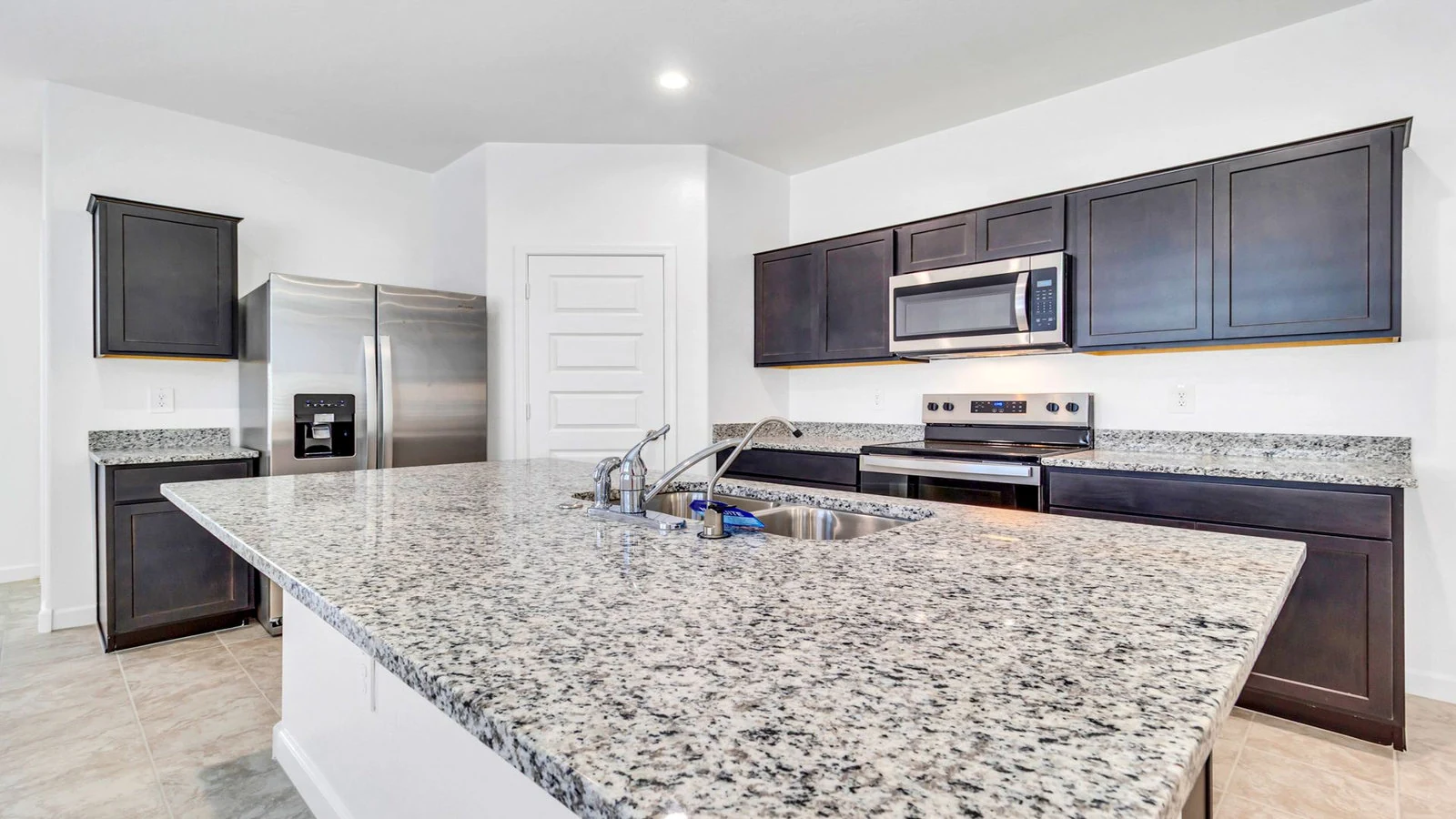 Kitchen granite island dark cabinets stainless steel real estate photography Apache Junction AZ | The Listing Bees