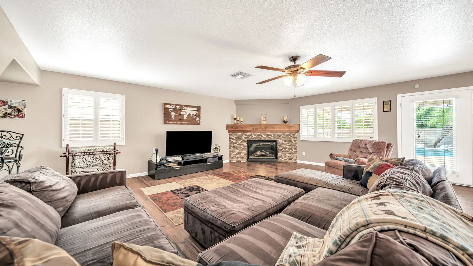Living room sectional sofa fireplace pool view real estate photography Glendale AZ | The Listing Bees