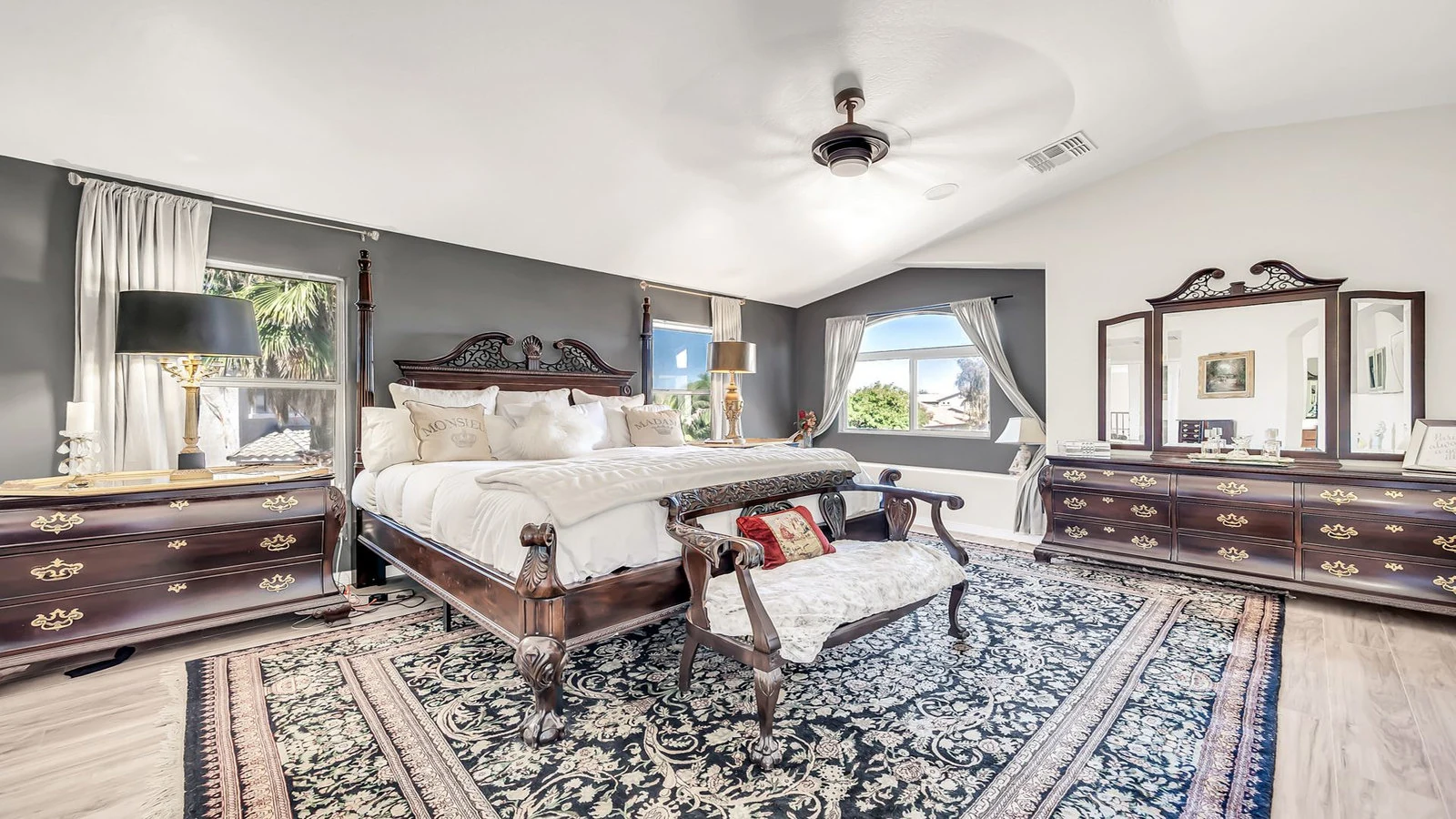 Luxurious bedroom large four-poster bed wooden furniture real estate photography Queen Creek AZ | The Listing Bees