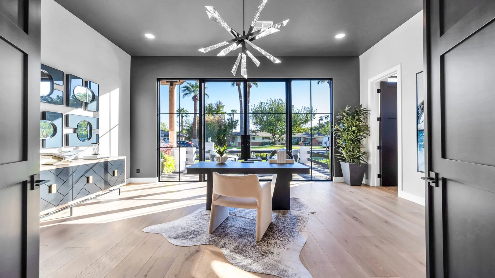 Modern home office with large windows and a view of Phoenix.