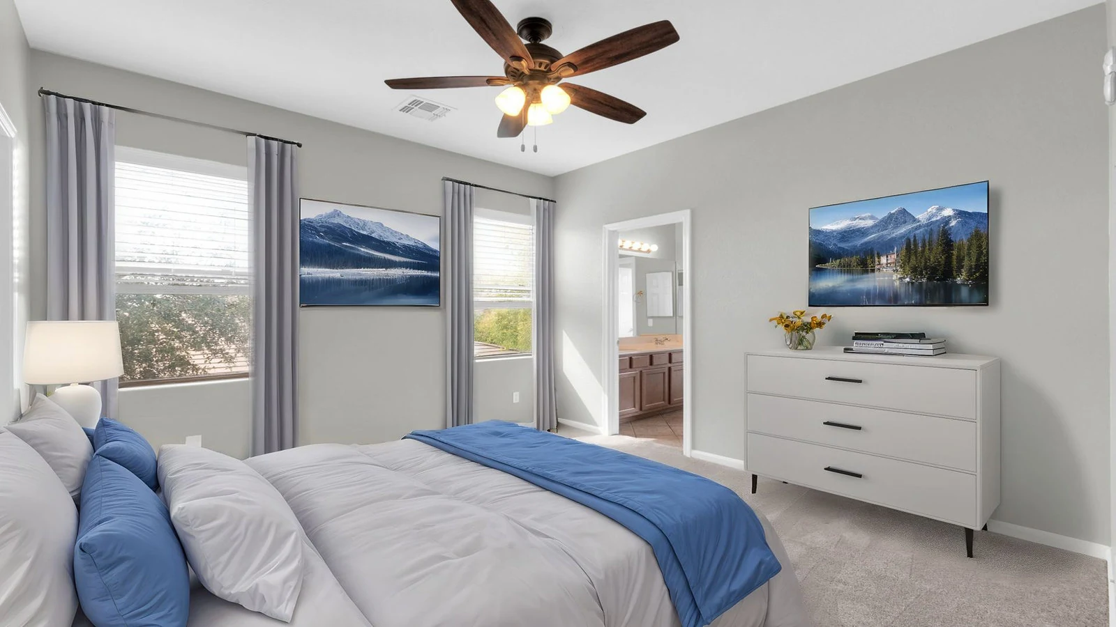 Modern bedroom blue bedding dresser ceiling fan real estate photography Queen Creek AZ | The Listing Bees