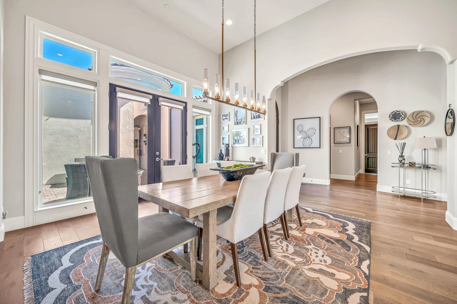 Modern dining room long table chandelier patio doors real estate photography Cave Creek AZ | The Listing Bees