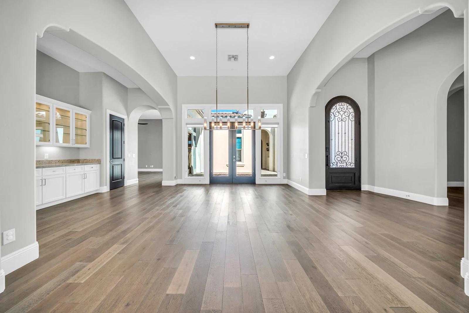 Modern home entryway hardwood floors arched openings real estate photography Cave Creek AZ | The Listing Bees