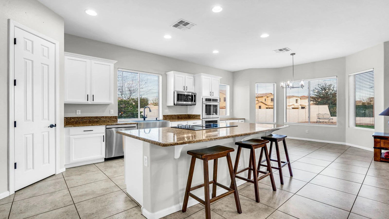 Modern kitchen island white cabinets large windows real estate photography Queen Creek AZ | The Listing Bees