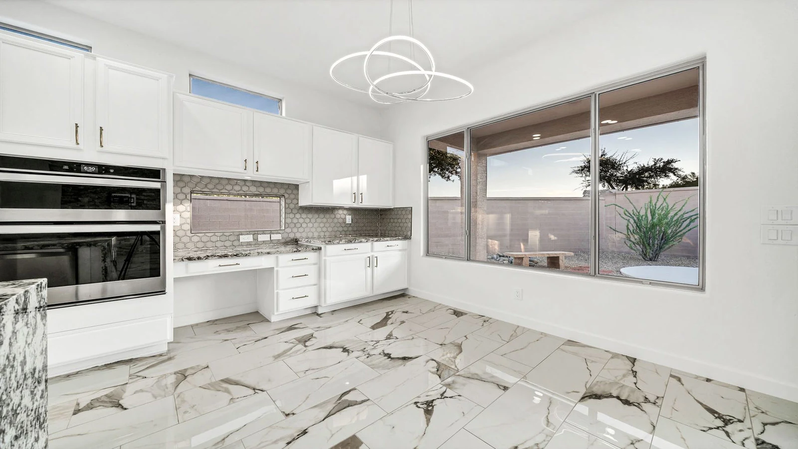 Modern kitchen white cabinets marble floor patio view real estate photography Goodyear AZ | The Listing Bees