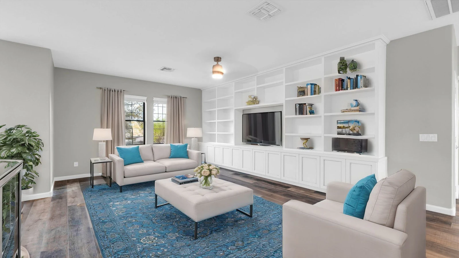 Modern living room built-in shelves TV blue rug real estate photography Queen Creek AZ | The Listing Bees