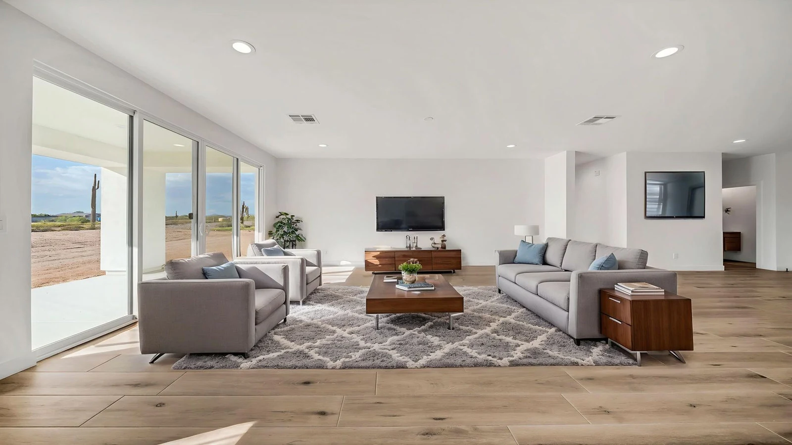 Modern living room gray sofa armchairs glass doors real estate photography Surprise AZ | The Listing Bees