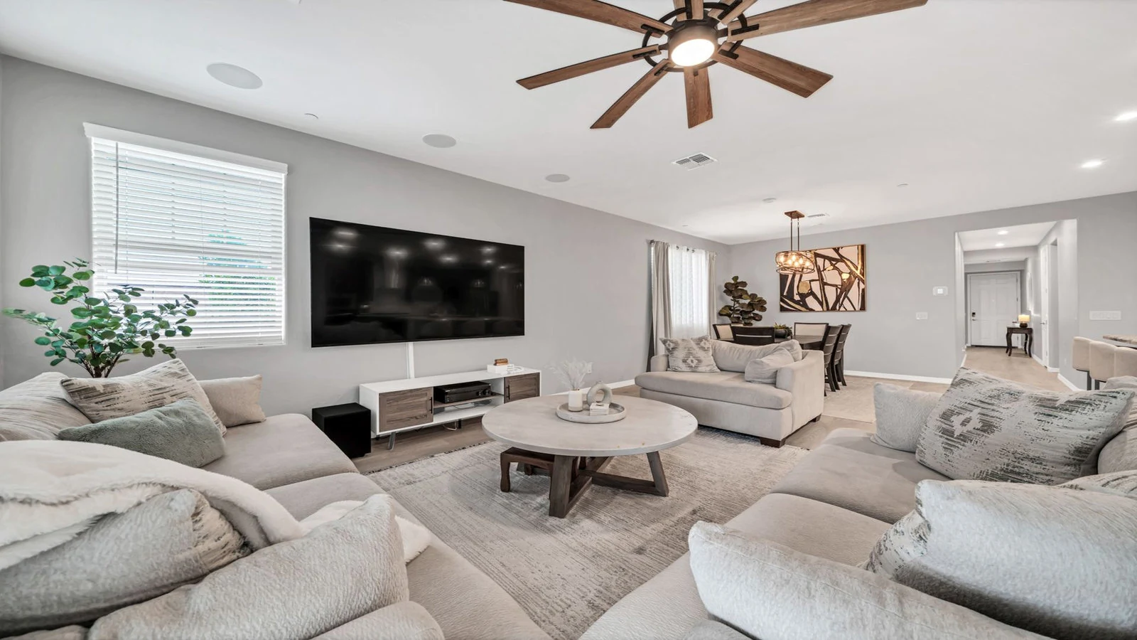 Modern living room large TV neutral sofas dining area real estate photography Peoria AZ | The Listing Bees