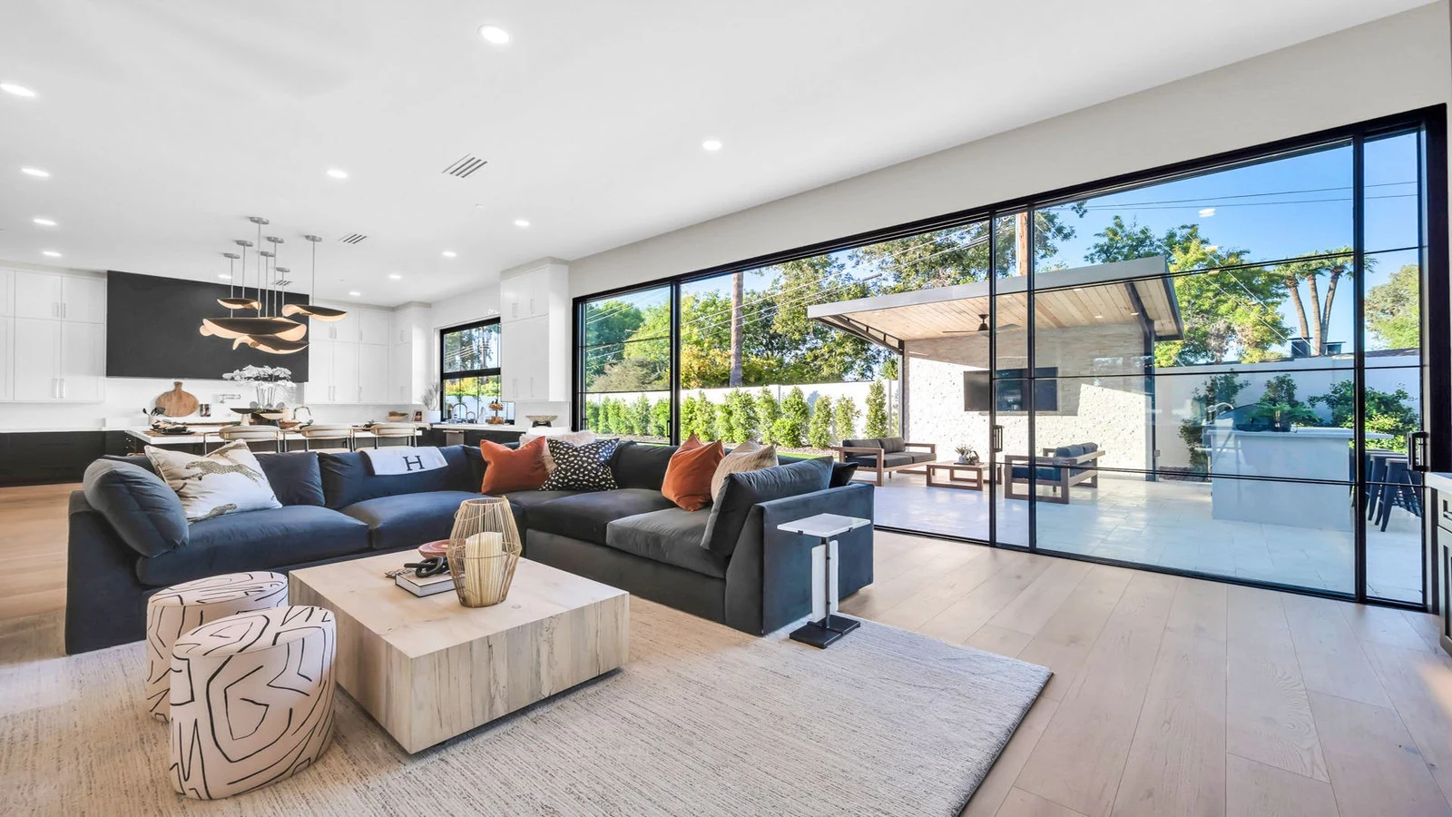 Modern living room with large windows and outdoor patio