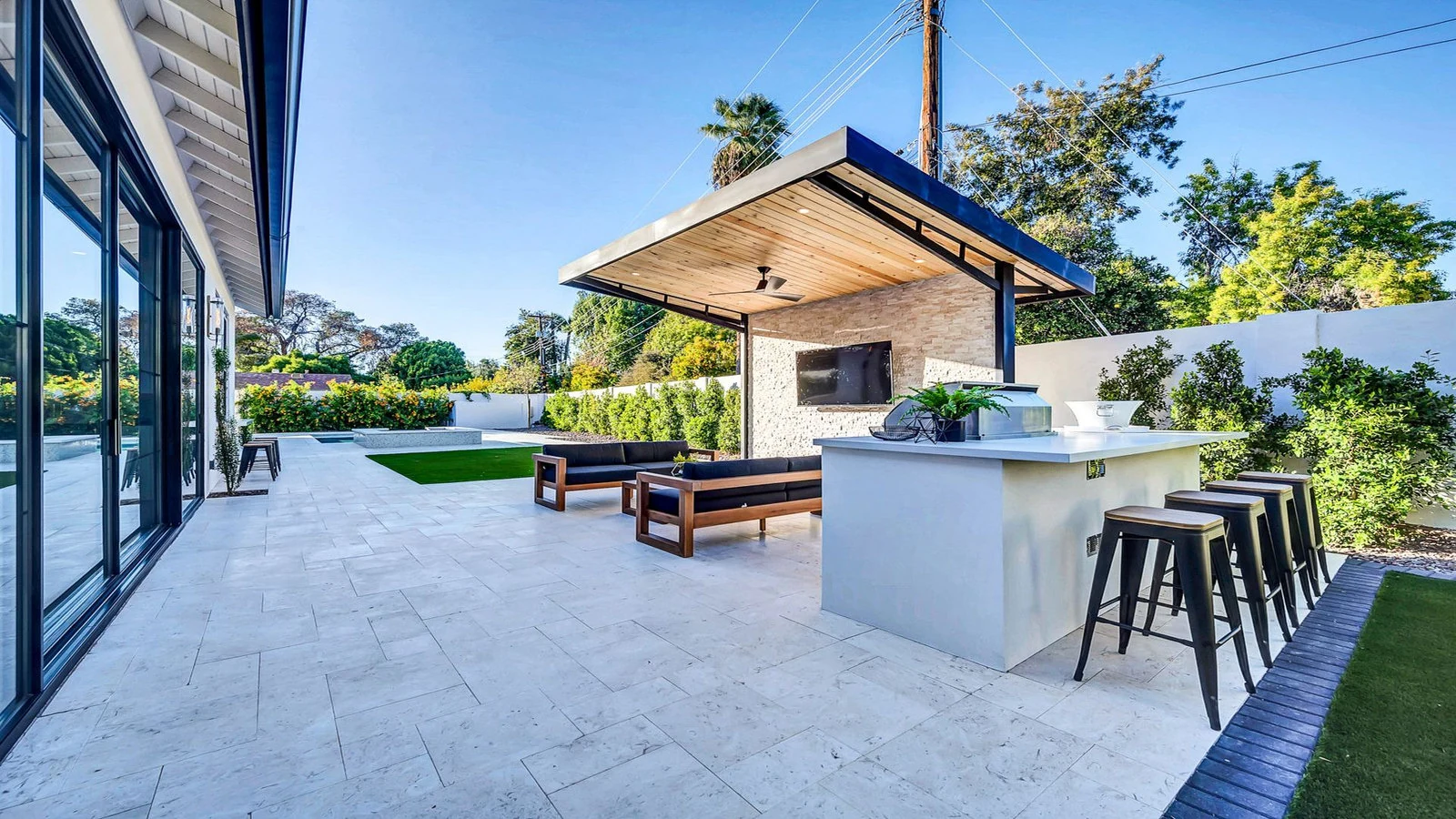 Modern outdoor living space with kitchen and patio