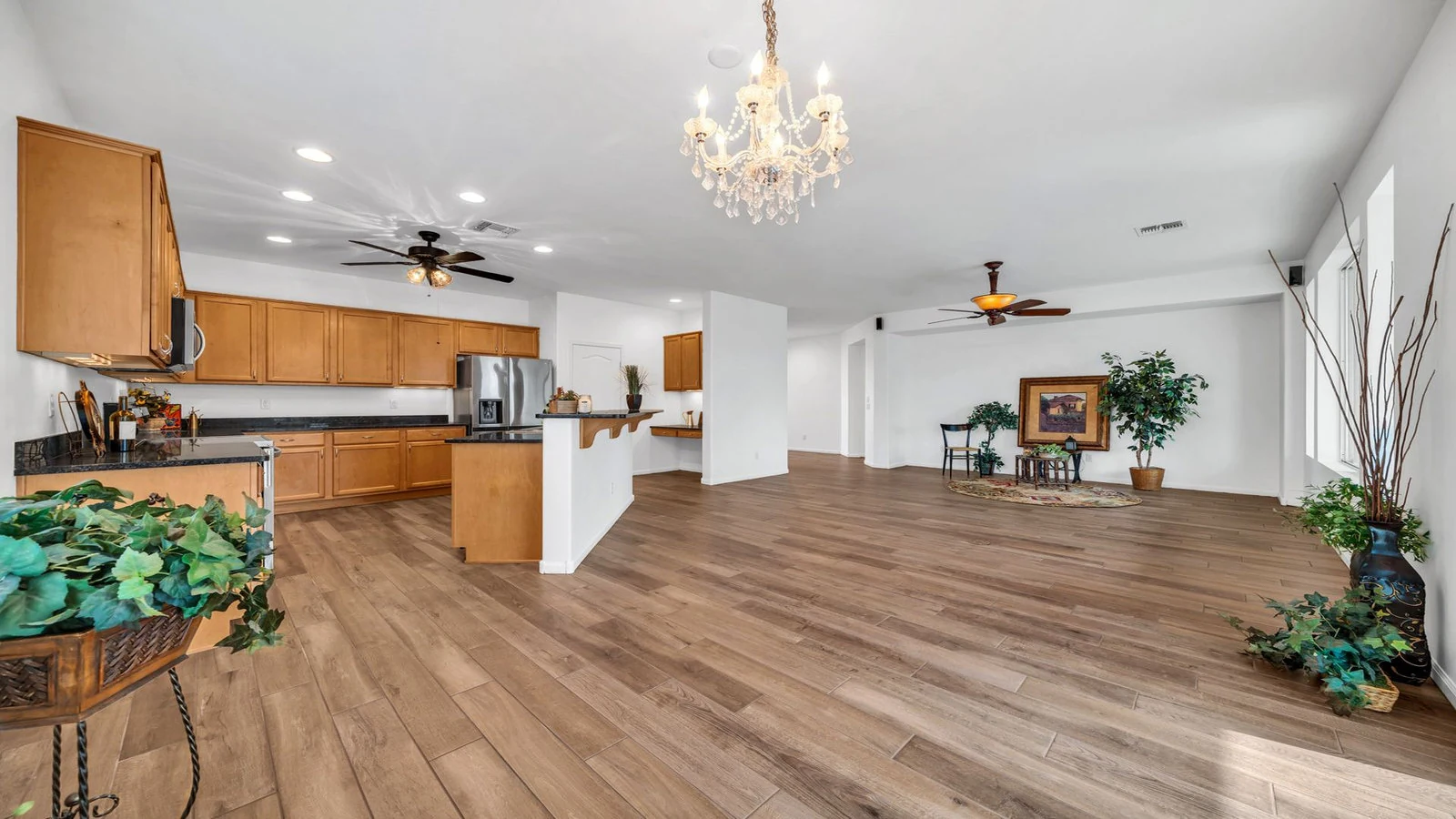 Open plan kitchen living room wood floor real estate photography Goodyear AZ | The Listing Bees