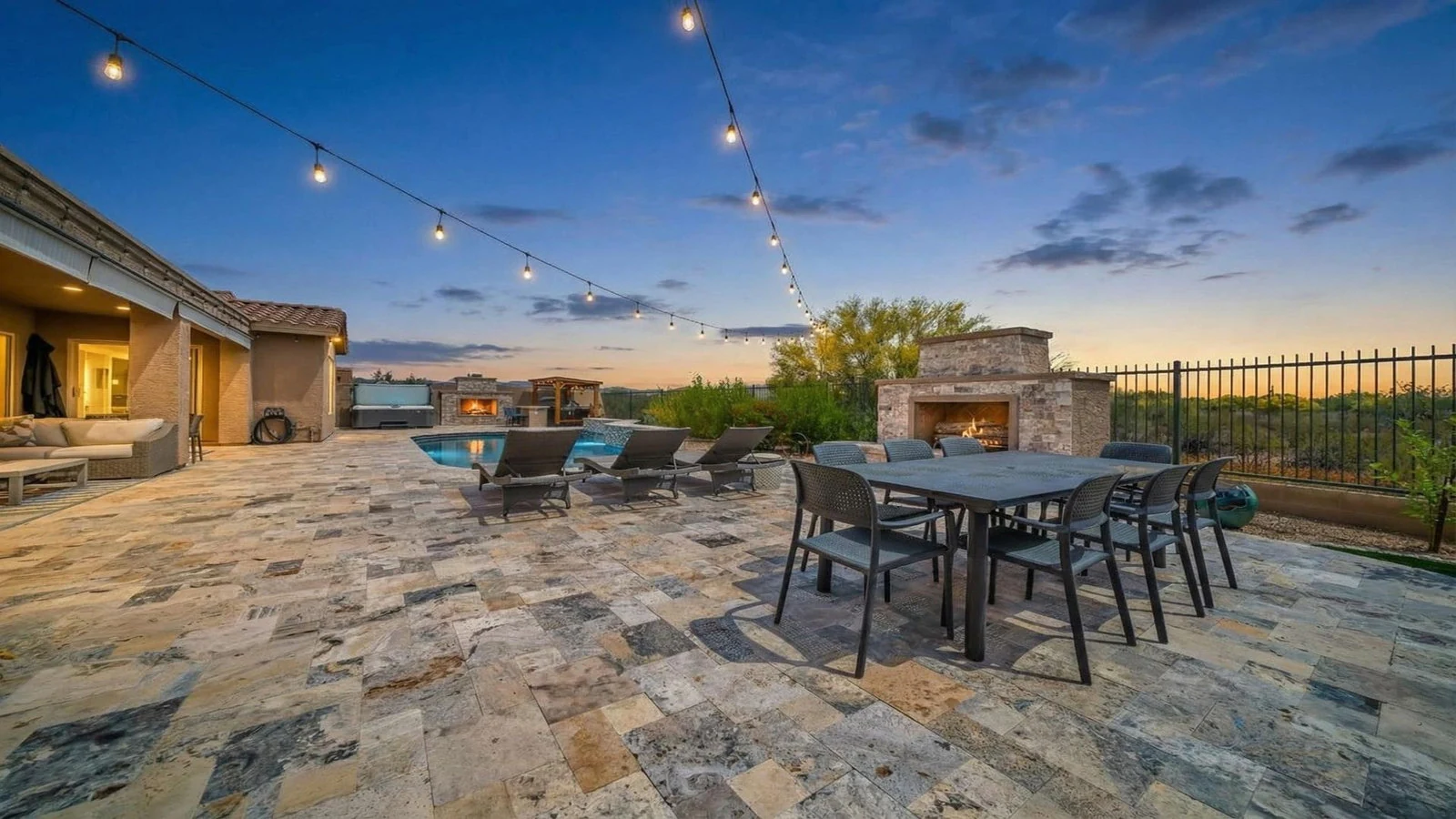 Patio pool dining fireplace string lights real estate photography Anthem AZ | The Listing Bees