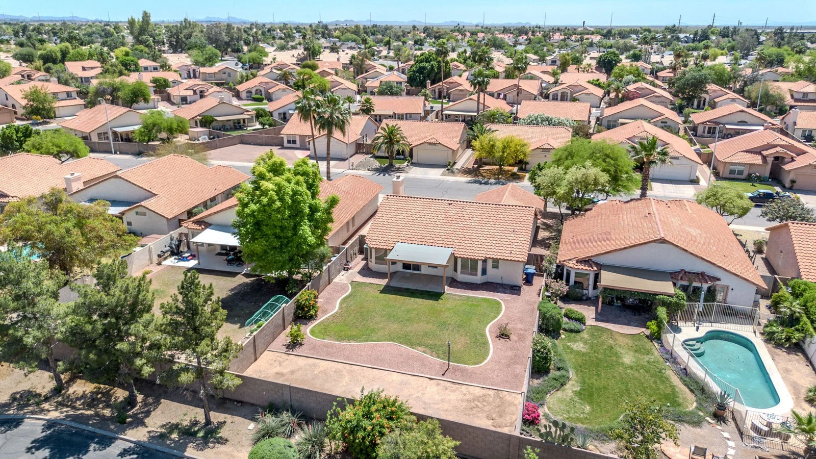 Aerial view of single-level homes and pools in a Sun Lakes 55-plus neighborhood, Chandler, AZ