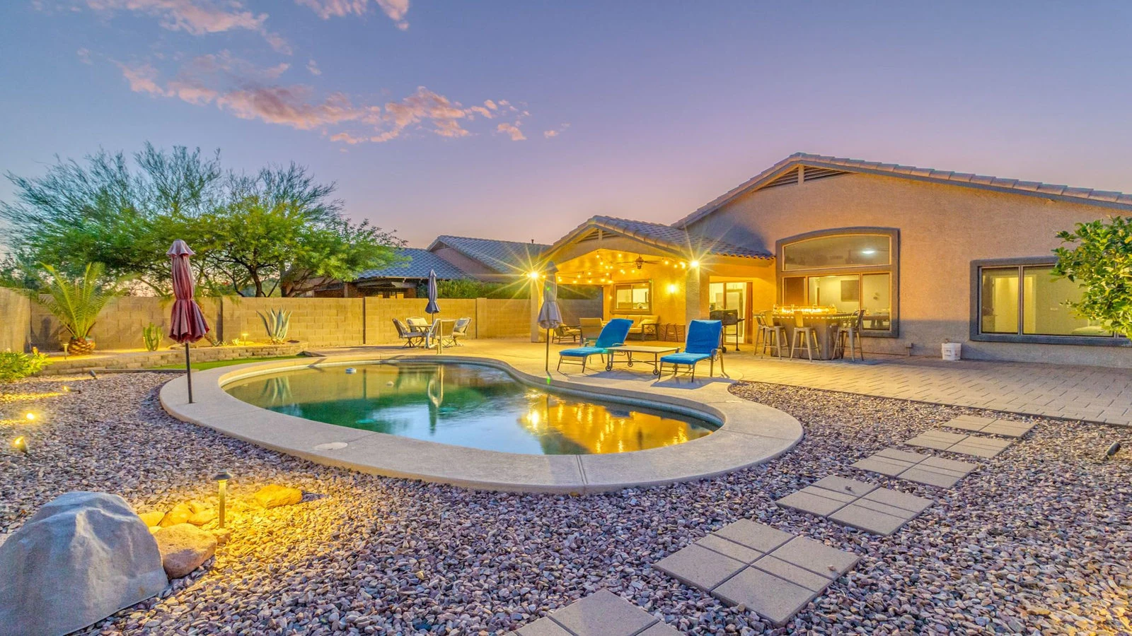 Backyard pool desert landscape lit house dusk real estate photography Gold Canyon AZ | The Listing Bees