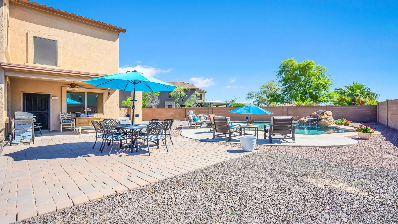 Spacious backyard patio dining pool lounge chairs real estate photography Queen Creek AZ | The Listing Bees