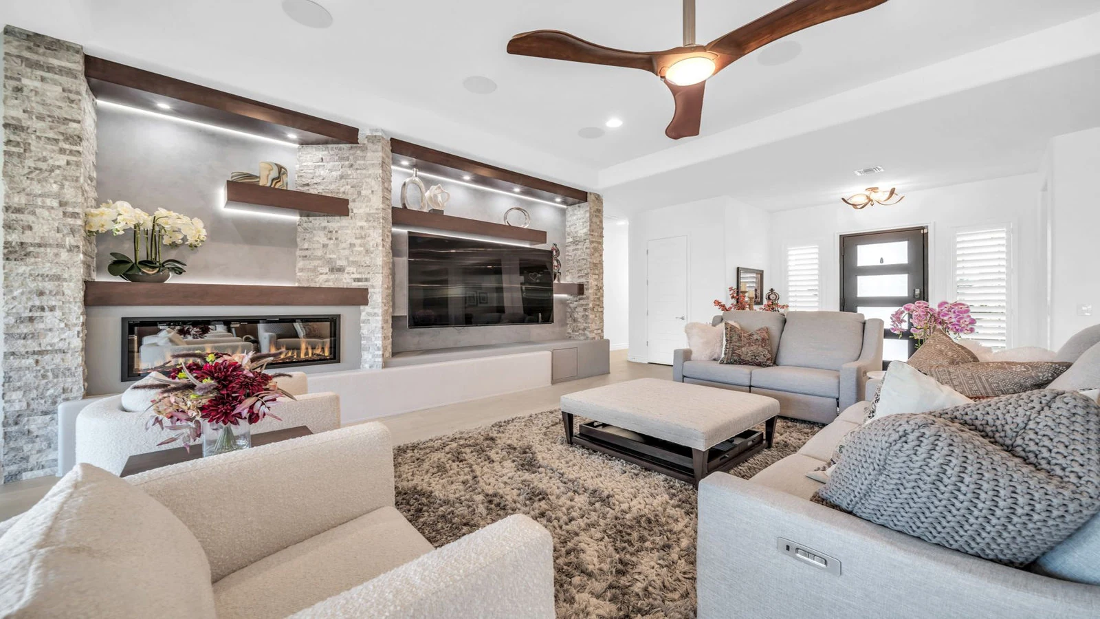 Spacious living room with fireplace, TV, and sofas