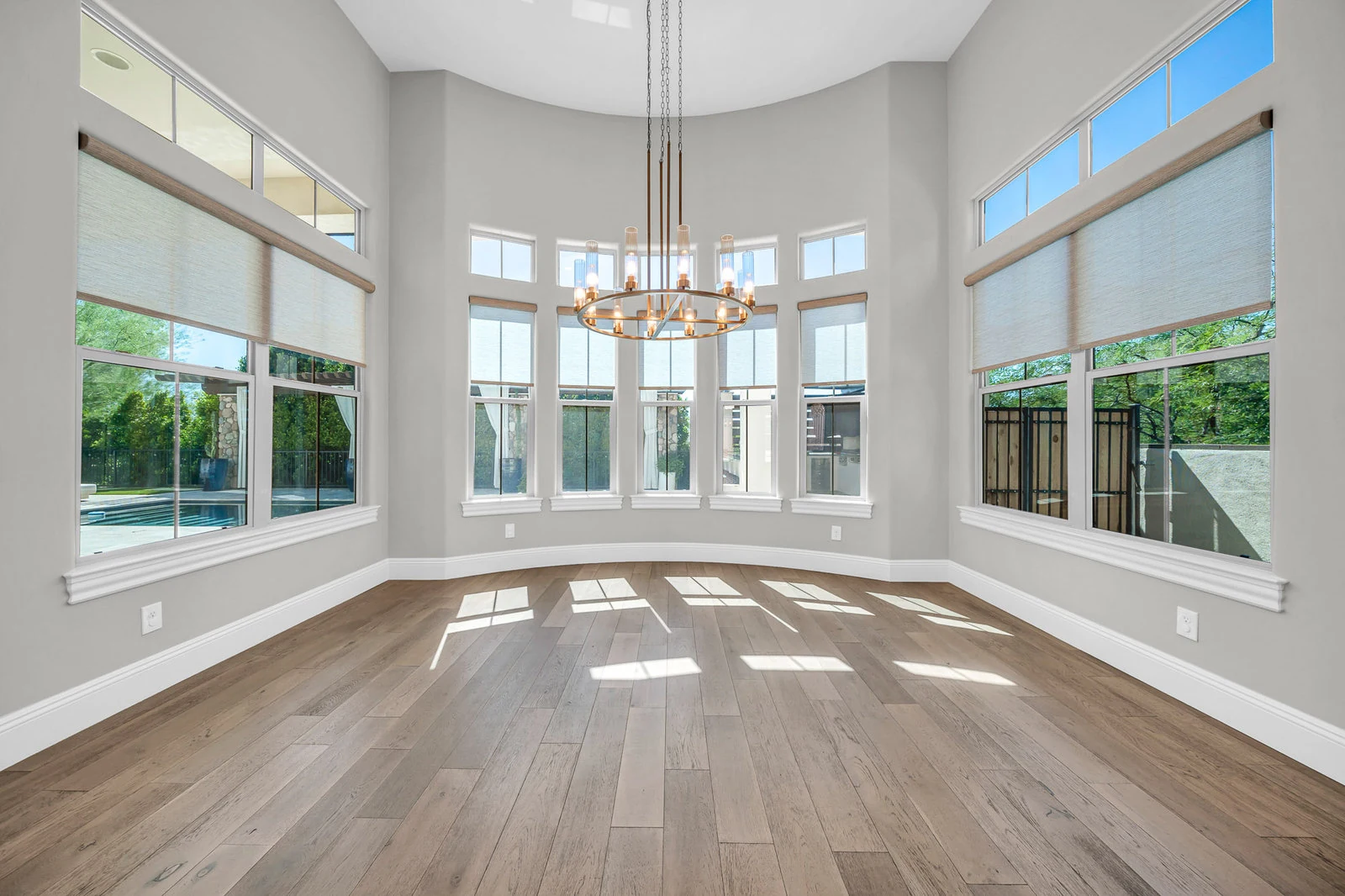 Spacious room large windows hardwood floor chandelier real estate photography Cave Creek AZ | The Listing Bees