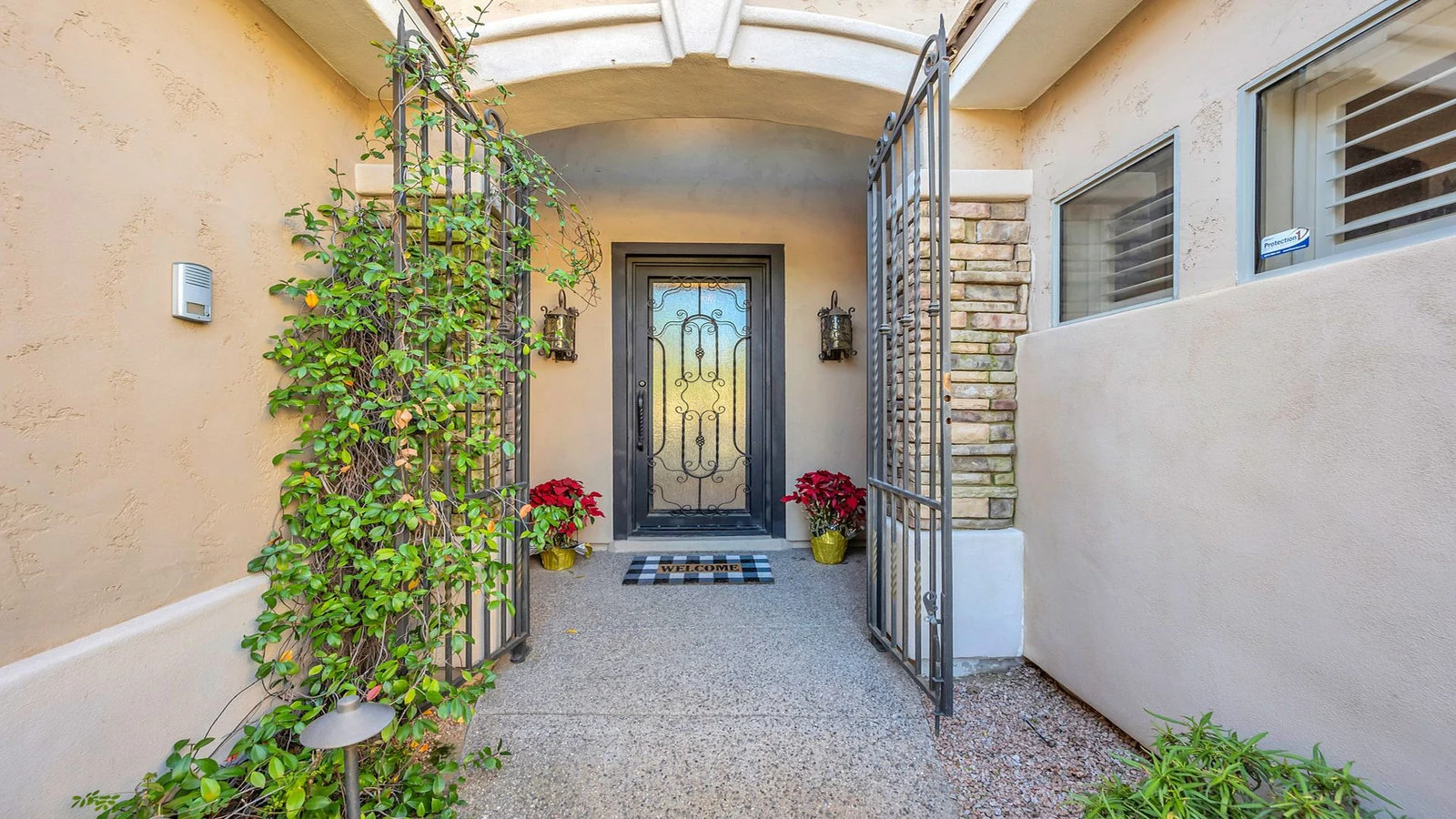 Ornate house entrance open iron gates red plants real estate photography Tempe AZ | The Listing Bees