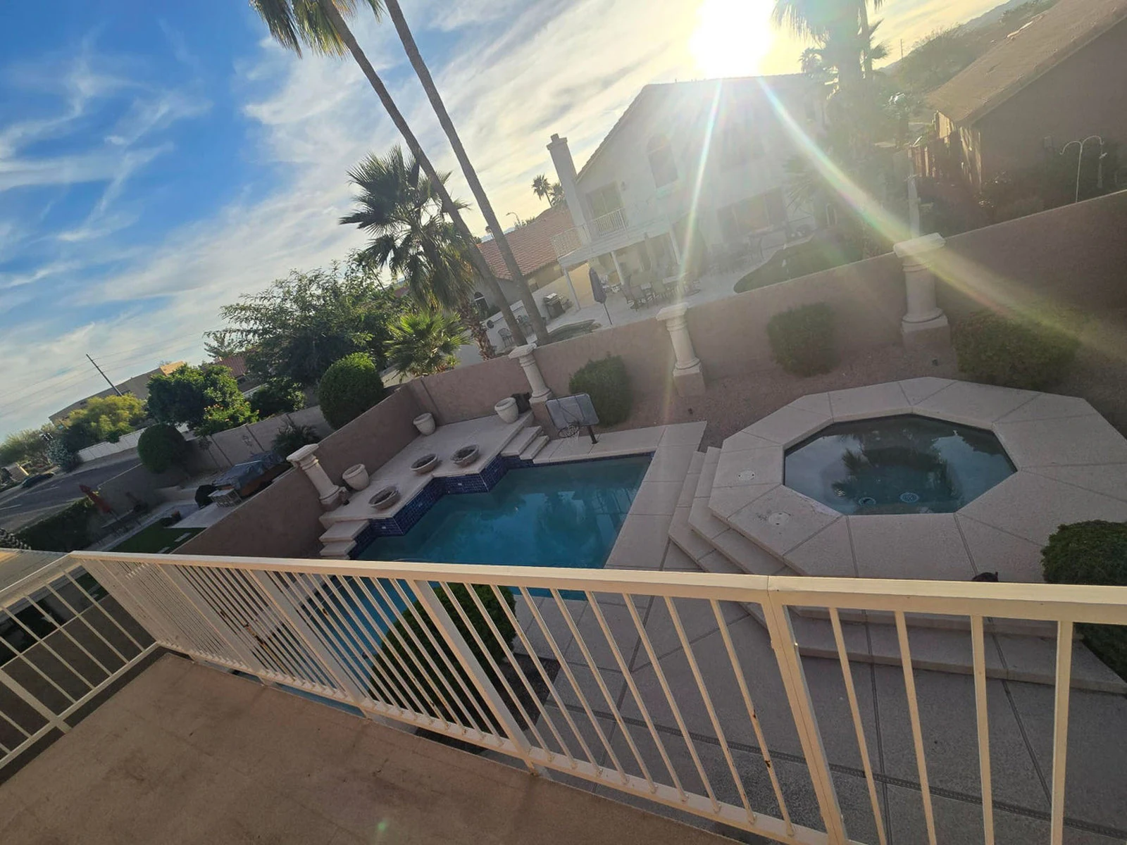 Sunny backyard with a pool, spa and covered patio in Ocotillo, Chandler, AZ