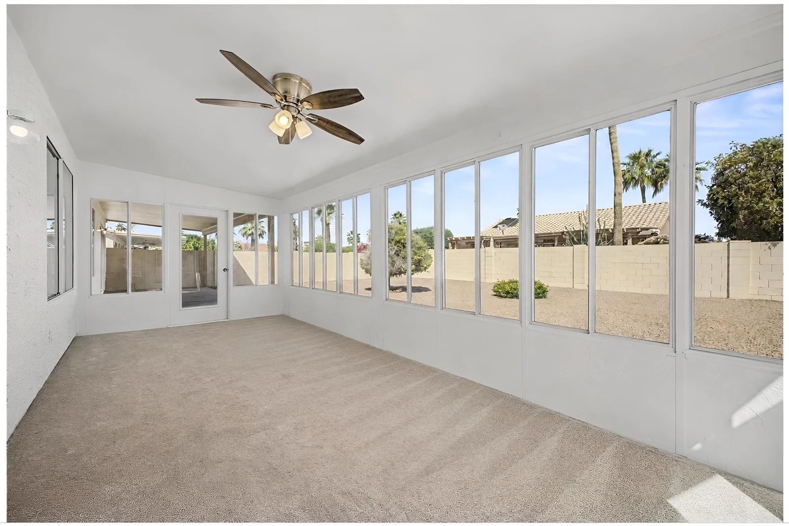 Empty Arizona room with carpet and a wall of windows
