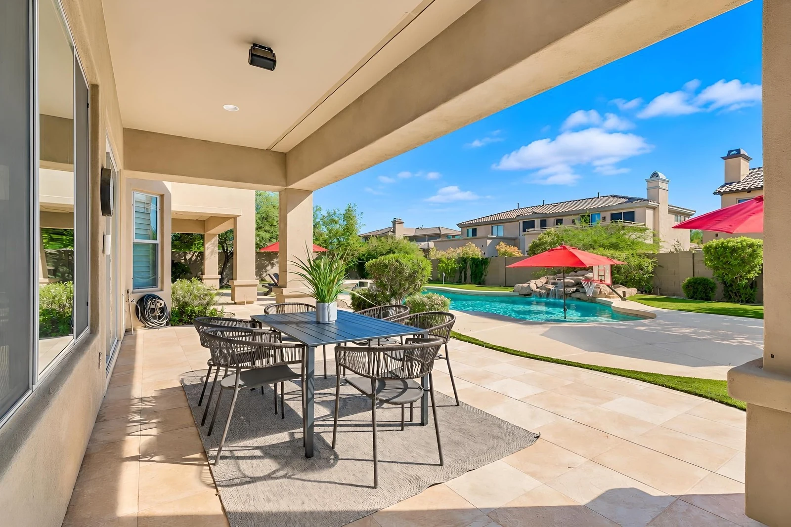 Covered patio and pool photographed in daylight