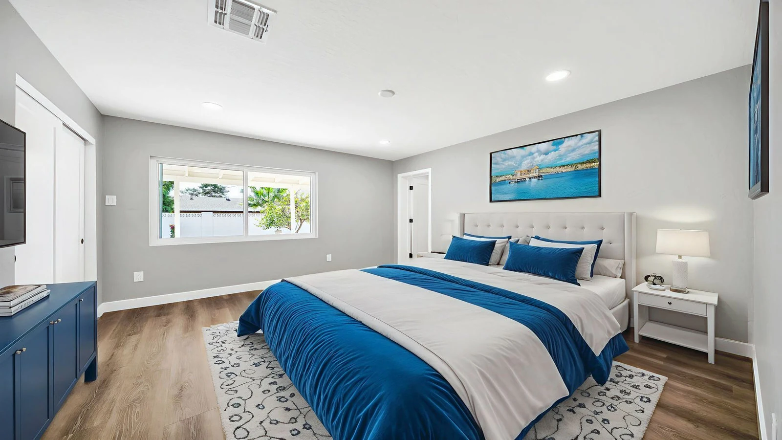 Virtually staged bedroom with modern blue and white decor