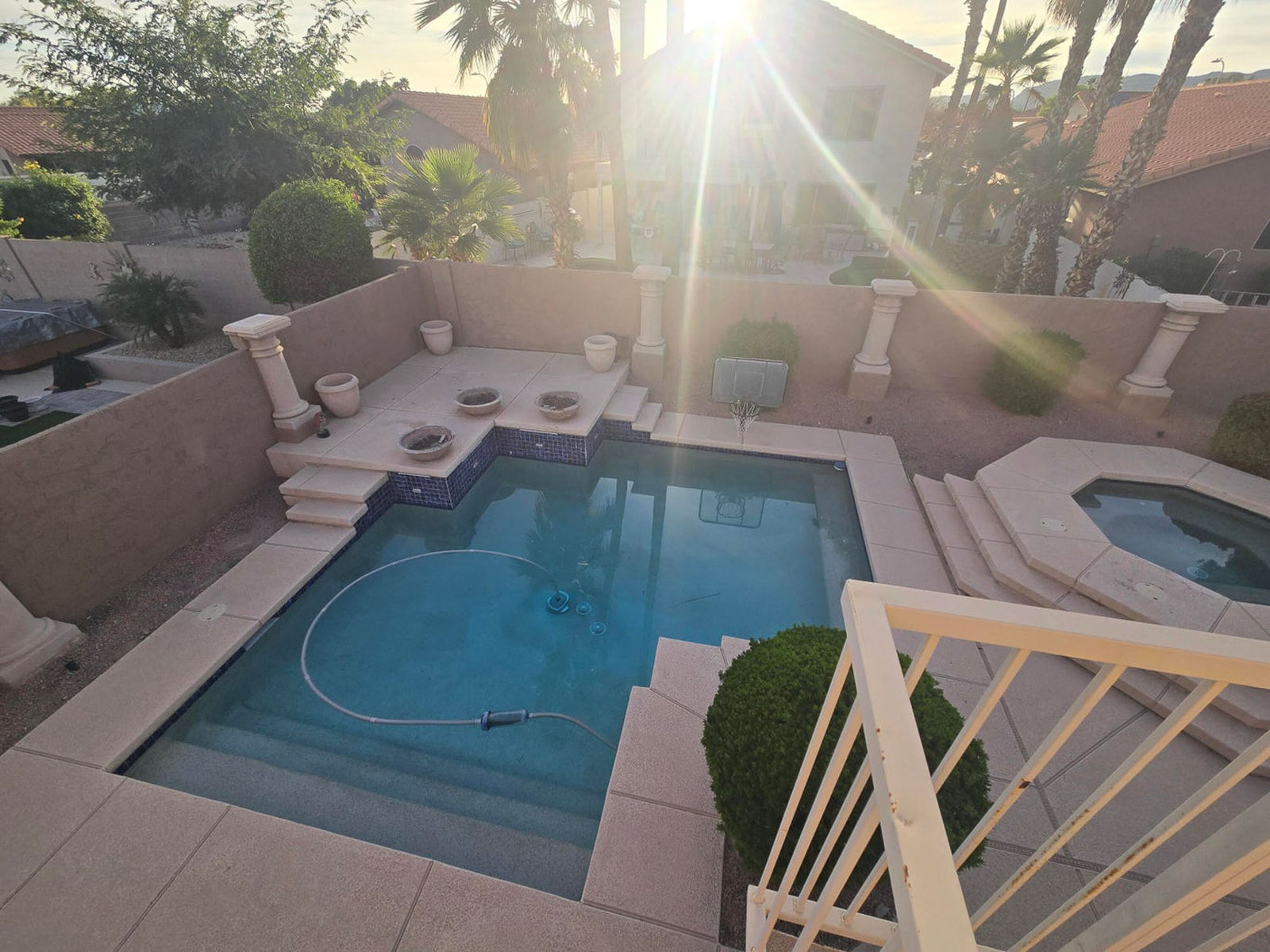 Twilight view of a backyard pool and hot tub in Chandler, AZ