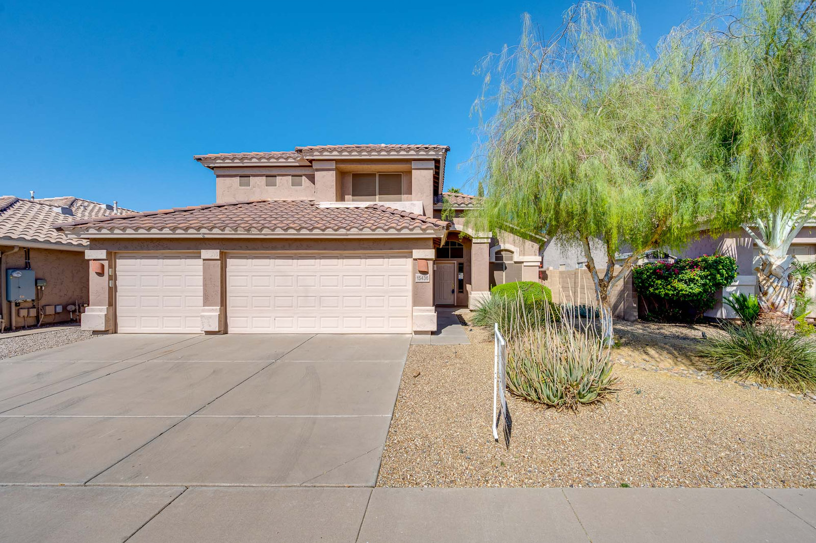 Two-story house with a two-car garage and desert landscaping